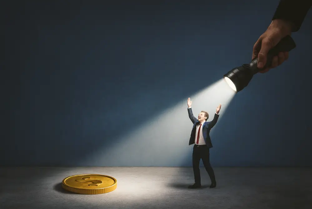 businessman celebrating as a flashlight shows a coin representing ai lead generation for found revenue